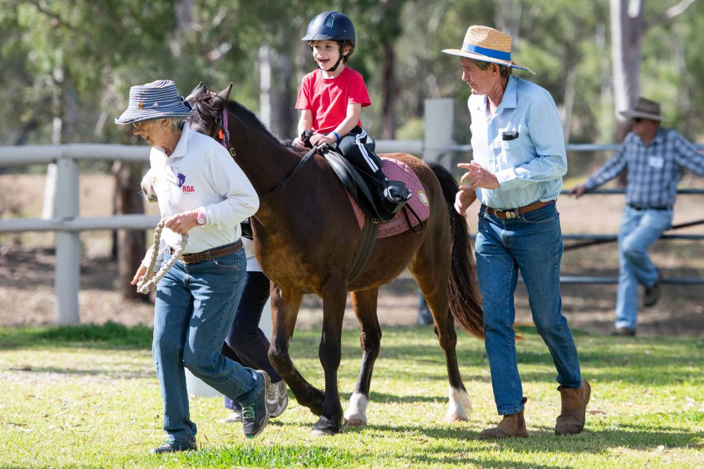 Young child being guided on horse