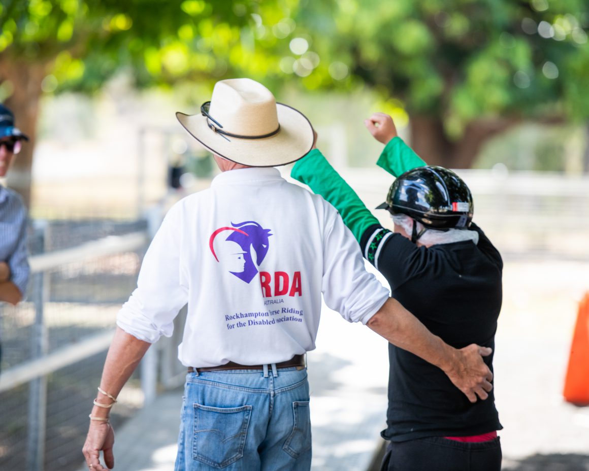 Man with cowboy hat and boy back view